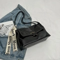 Glossy black crossbody bag with white stitching and decorative silk scarf detail - Black