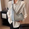 Minimalist light blue matte leather hobo bag with adjustable wide strap and silver text - Blue