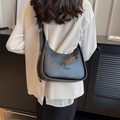 Minimalist black crescent shoulder bag in matte faux leather with adjustable silver buckle - Black