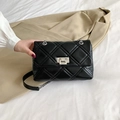 Elegant black quilted crossbody bag with silver chain strap and metallic twist lock clasp - Black