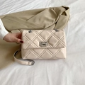 Elegant cream quilted crossbody bag with silver chain strap and metal twist lock - Beige
