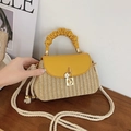 Fashionable yellow woven straw crossbody bag with leather handle and flower charm - Yellow