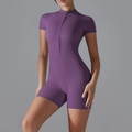 Slim fit dark purple yoga romper with short sleeves and a front zipper closure - S / Purple Thistle