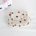 Detailed macro view of cream corduroy coin purse with colorful heart patterns and resin snap - Colorful Heart