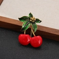 Charming red cherry brooch featuring green enamel leaves and golden floral accents - Style 11 (Red/Green/Gold)