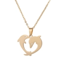Close-up of golden dolphin heart pendant necklace with high-polish finish on fine link chain - Dolphin Heart Gold (718)