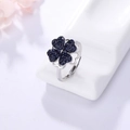 Adjustable silver ring featuring a rotatable four-leaf clover with dark blue crystals - Ring-Black