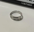 Macro detail of silver adjustable ring featuring an engraved never give up slogan - Never Give Up Style (081) / Steel
