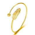 Detailed close-up of golden feather leaf open cuff bracelet with polished bead detail - Gold