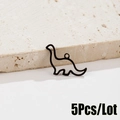 Detail view of 5pcs black cutout stainless steel dinosaur charms on white stone base - Brachiosaurus Style (562) / 5 Pieces / Black