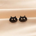 Macro shot of black cat stud earrings with gothic stitch smile and cutout eyes - Black