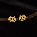 Gothic gold cat skull earrings on wooden branches for Halloween jewelry display - Gold