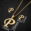 Golden letter P necklace and earrings set in stainless steel with a black glitter base - Letter P Gold