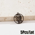 Close-up of 5 black hollowed-out metal leaf pendants for jewelry making on stone - 5 Pcs/Bag / Black