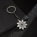 Silver stainless steel keychain featuring a hollow flower pendant and black bead center - Eight-Petal Linear Flower (197)