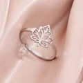 Adjustable silver maple leaf ring with hollow-out design on elegant satin background - Steel