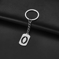 Minimalist silver stainless steel rectangular hollow keychain on black leather background - Number 0
