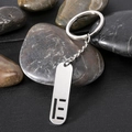 Polished stainless steel rectangular tag keychain with hollow stripes on dark stones - Letter E