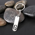 Polished silver stainless steel keychain with rectangular tag and hollow letter G - Letter G
