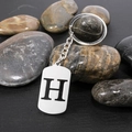 Polished silver stainless steel keychain featuring a cut-out uppercase letter H pendant - Letter H