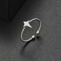 Close-up of silver twist ring featuring a minimalist four-pointed star and bead ends - Four-pointed Star Style (321) / Steel