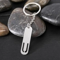 Sleek silver stainless steel rectangular keychain on smooth stones background - Letter U