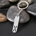 Polished stainless steel keychain with cutout letter X on a rectangular pendant - Letter X