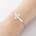 Silver cross pendant bracelet with intricate hollow pattern shown on a wrist - Vintage Floral Hollow Cross (4)-Steel Color