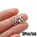 Macro detail of bicycle charm pendant in brushed stainless steel for DIY jewelry - Steel