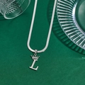 Silver crown letter L pendant on a sleek herringbone chain against a dark green base - Letter L