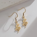 Golden zodiac snake dangle earrings in polished stainless steel with intricate cutouts - Gold
