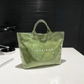 Borsa tote verde erba con finitura lucida impermeabile e scritta TOTE BAG bianca - Verde