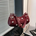 Deep red crescent shoulder bag in glossy patent leather with bold silver studs - Burgundy