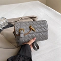Chic grey hand-woven leather crossbody bag with a gold twist lock and adjustable strap - Gray