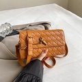 Handwoven caramel brown crossbody bag with gold-tone knot clasp and leather texture - Ginger Yellow