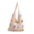 Off-white knit tote bag featuring colorful 3D crochet flowers and wide shoulder strap - Colorful