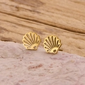 Close-up of gold stainless steel seashell earrings on a pink textured mineral stone - Gold