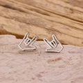 Polished stainless steel hand gesture stud earrings on natural stone background - Steel