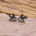 Macro detail of matte black stainless steel earrings featuring I Love You hand gesture - Black