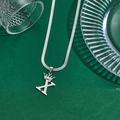 Minimalist silver crown necklace featuring letter X pendant on flat snake chain - Letter X