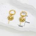 Gold stainless steel hoop earrings with delicate dandelion charms on a stone surface - Dandelion Gold