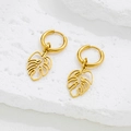 Pendientes minimalistas de hoja de monstera en oro de 18K sobre fondo de piedra - Dorado