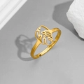 Detailed close-up of golden monstera leaf ring with adjustable open band on grey background - Leaves Gold