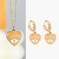 Detail of gold evil eye heart jewelry set featuring orange enamel and sunburst lines - Orange