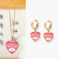 Detail of pink enamel evil eye heart pendant and matching earrings in gold-plated steel - Rose Red