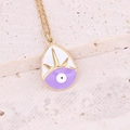 Macro shot of gold waterdrop enamel pendant with evil eye motif on stone surface - Teardrop Purple Evil Eye