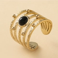 Macro shot of gold hammer-textured ring with a black oval gemstone and gold beads - Adjustable Open / Black