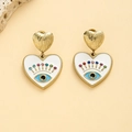 Golden heart earrings with white enamel and multi-colored gemstone evil eye detail - White