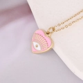 Pink heart pendant necklace in 14k gold plated finish with evil eye enamel detail - Pink
