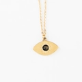 Close-up of golden stainless steel necklace featuring evil eye pendant with black stone - Brown